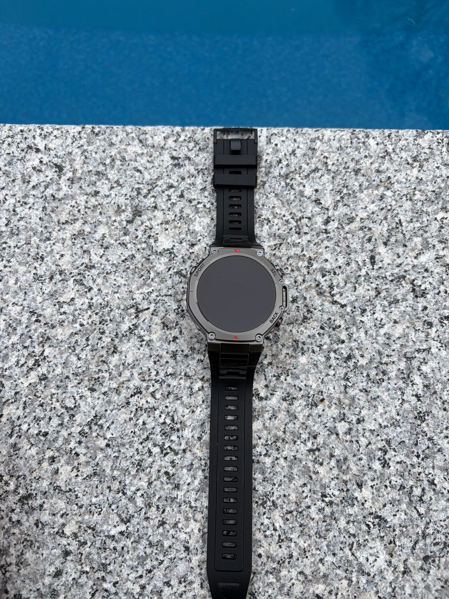 Forge Genesis smartwatch charging on magnetic dock, waterproof rating IPX8