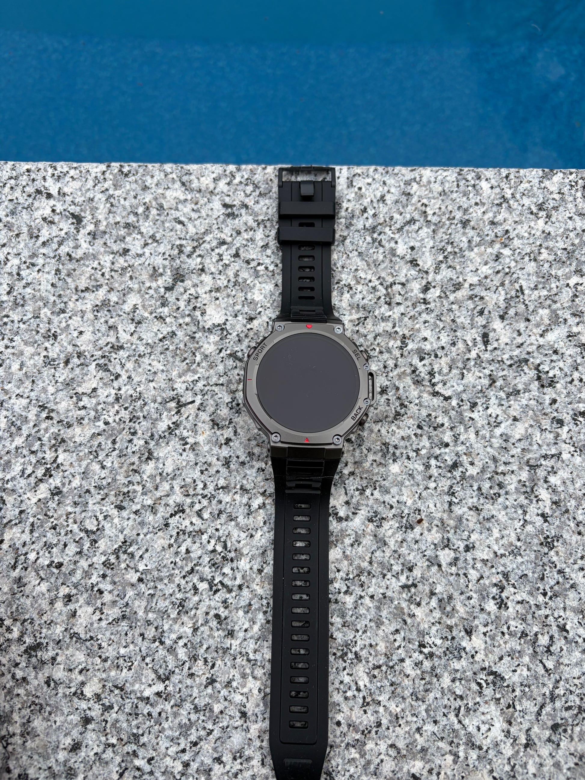 Forge Genesis smartwatch charging on magnetic dock, waterproof rating IPX8